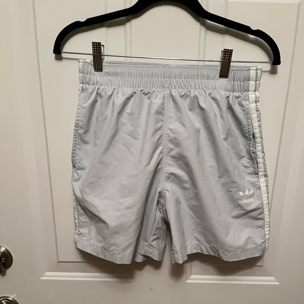 Men’s Adidas 3 stripe, mesh lined swim shorts. Mid rise